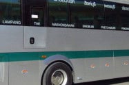 Bus at Arcade Bus Station in Chiang Mai with passengers boarding and alighting.