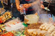 Street food stall at Chiang Mai Saturday Night Market with skewers and eggs.