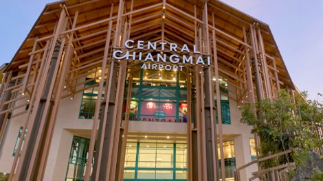 Exterior view of Central Chiangmai Airport with modern architecture and wooden accents.