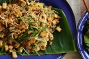 Traditional Thai dishes served on banana leaves at Ploen Ruedee Market in Chiang Mai.