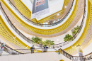 Interior view of Central Festival Chiang Mai shopping mall with yellow and white design.